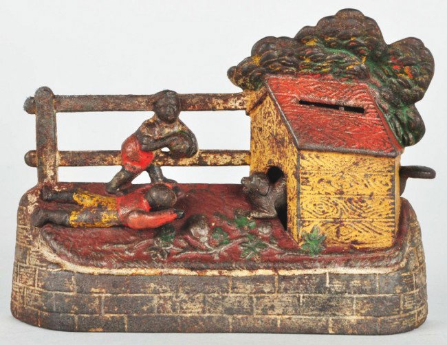 Cast Iron Boy Stealing Watermelon Mechanical Bank: Manufactured by Kyser & Rex. Working. Includes original key. Size: 6 - 1/2" L. Condition: (Good - Very Good). CORRECTION – Includes key for replaced trap.
