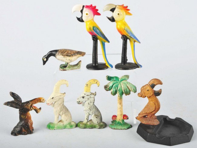 Lot of 8: Cast Iron Bottle Openers.: Made by John Wright. Includes two parrots on perch, one palm tree, two goats, one donkey, one Canadian goose, and one cockatoo. Size: Largest: 5 - 1/2" T. Condition: (Very Good).