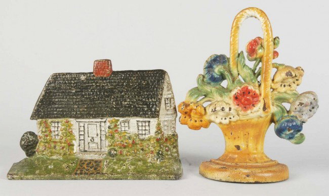Lot of 2: Cast Iron Doorstops.: Includes one cottage by National Fdry. Co. and one cosmos by Hubley. Size: Largests: 8 - 1/2" T. Condition: (Very Good).