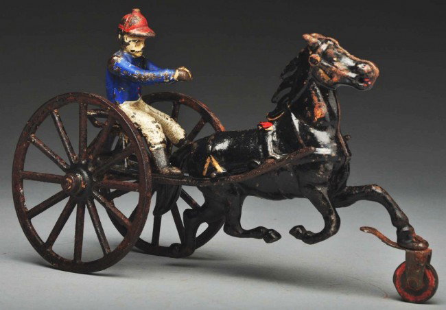 Cast Iron Sulky Horse-Drawn Toy.: American Made by Pratt and Letchworth. Includes original driver. All original paint. Size: 9" L. Condition: (Very Good).