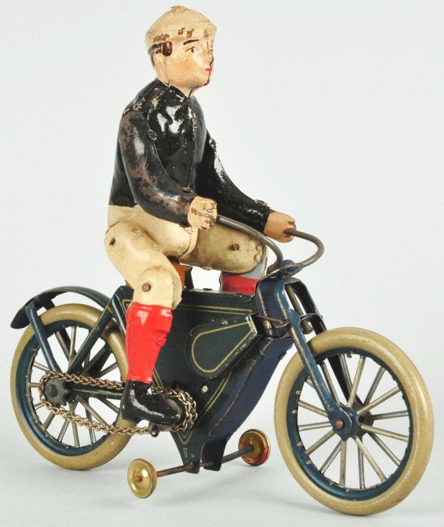 Tin Guntherman Motorcycle Wind-Up Toy.: German. Working. Chain driven. Handpainted figure with tin litho motorcycle. Marked "Made in Germany" behind seat. Original training wheels. Legs are articulated. Some paint loss to top half of figure