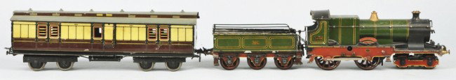 Bassett Lowke No. 440 Steam Loco & Baggage Car.: English outline. Beautiful and extremely rare set with clockwork motor and cast iron frame. Wonderfully handpainted and all original. Baggage car with lithographed sides and handpainted roof and 3410 