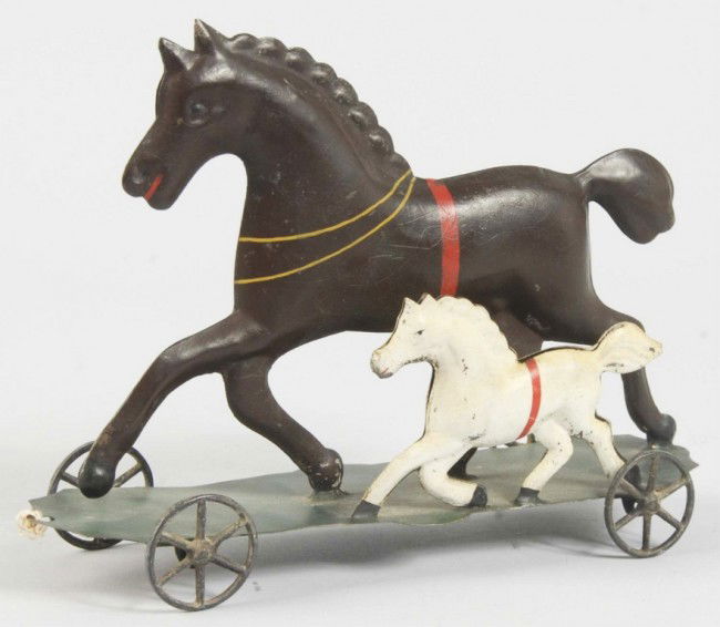 Early Tin Horse Platform Toy.: American. All tin with iron wheels. Depicts one smaller horse riding beside larger horse. Appears to have old restoration. Size: 8 - 3/4" L. Condition: (Restored).