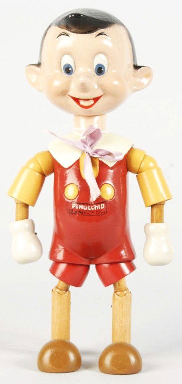 Walt Disney Ideal Jointed Pinocchio Figure.: American. Medium size variation. Marked "W.D.P." on back of head and painted "Pinocchio" across chest. Doll has very little crazing but has several sections of restoration throughout. Size: 10 - 3/4"