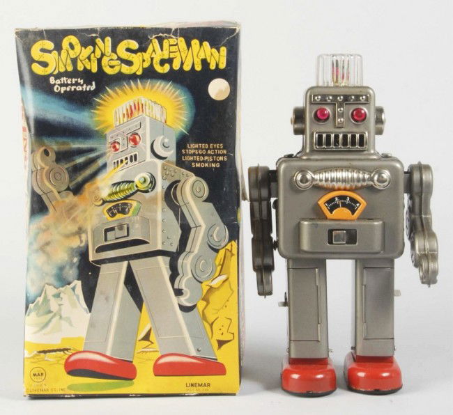 Tin Litho Linemar Smoking Spaceman Battery-Op Toy: Japanese. Working. Robot has clean battery box in legs. Some slight pitting and wear overall. Includes original box with cardboard inserts. Box has some creasing, waviness, and staining. Size: 12" T.