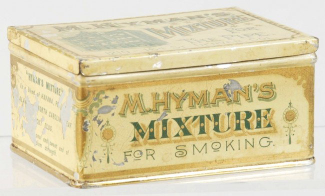M. Hyman's Mixture Pipe Tobacco Tin.: Nice image of store on front of tin. Size: 3 - 1/4" x 4 - 1/2". Condition: (Excellent Plus).