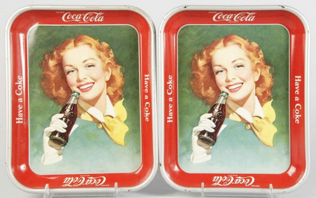 Lot of 2: Coca-Cola Serving Trays.: 1950s. Includes one with strong dent in upper left corner, minor rust, and small marks. The other tray has only light wear. Size: Each: 13 - 1/4" x 10 - 1/2". Condition: (Very Good - Excellent).