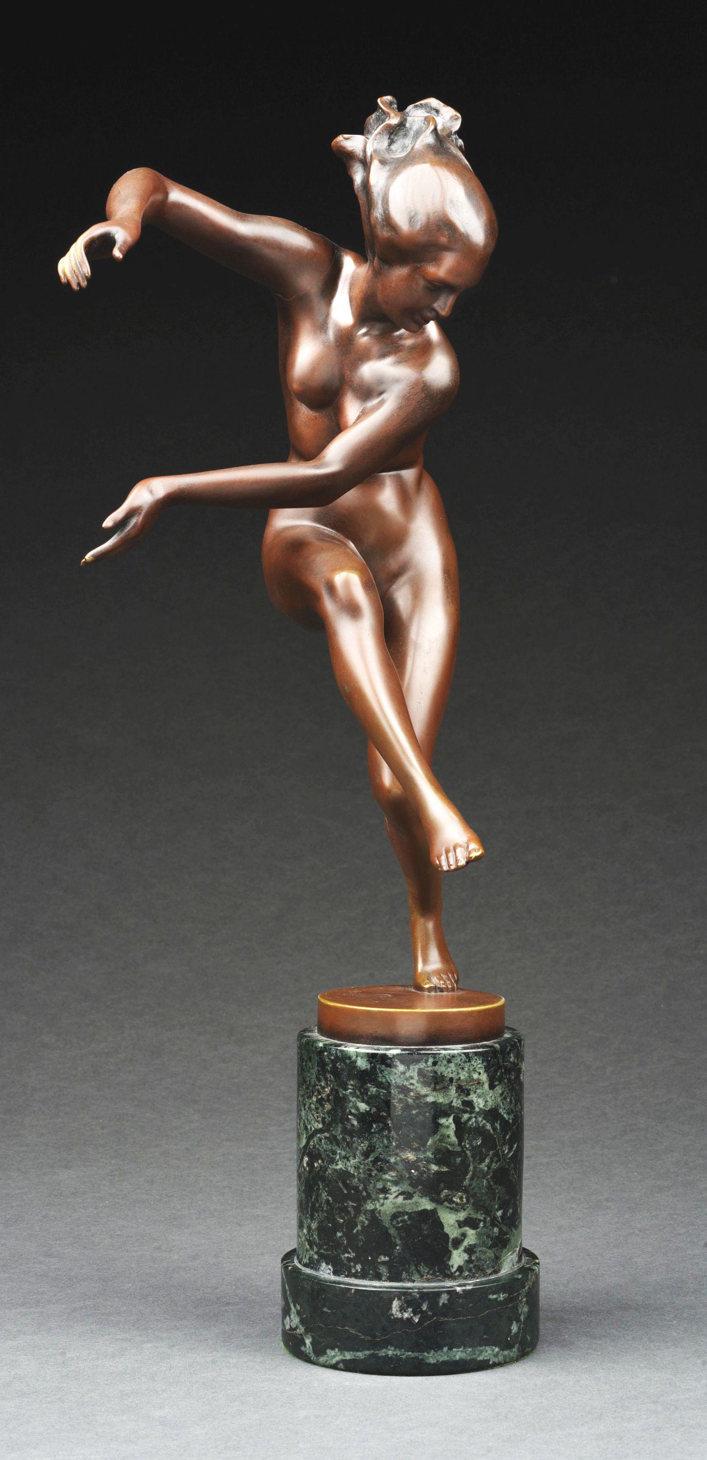 KARL PERL (AUSTRIAN, 1876 - 1965) BRONZE SCULPTURE OF DANCING NUDE WOMAN ON GREEN MARBLE BASE.: A beautiful motion bronze sculpture on a raised green marble base of a nude woman dancer in a graceful and expressive pose, perched on one foot. It is in an original dark brown patina, signed in the p