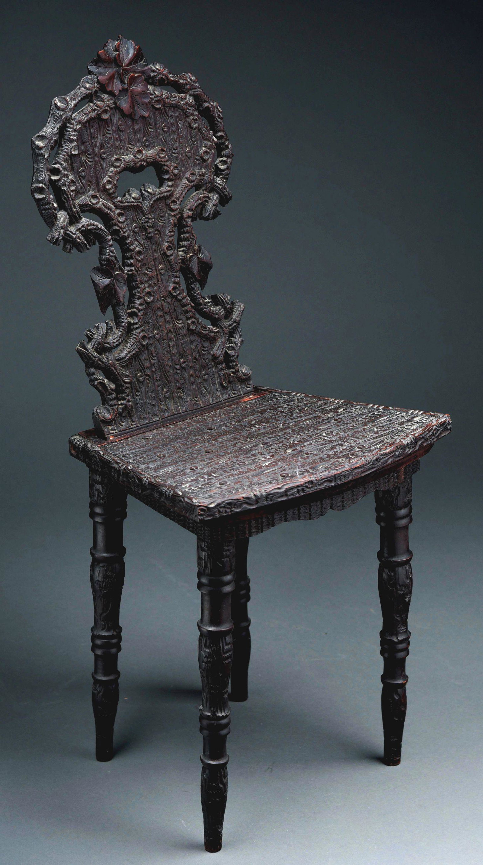 VICTORIAN ADULT SIZE MUSICAL CHAIR WITH 3" CYLINDER.: Black Forest carved musical chair with wonderful wooded carvings, playing a 3" cylinder and two tunes. Activated when seated. Condition is wonderful with little wear, working properly and a great earl