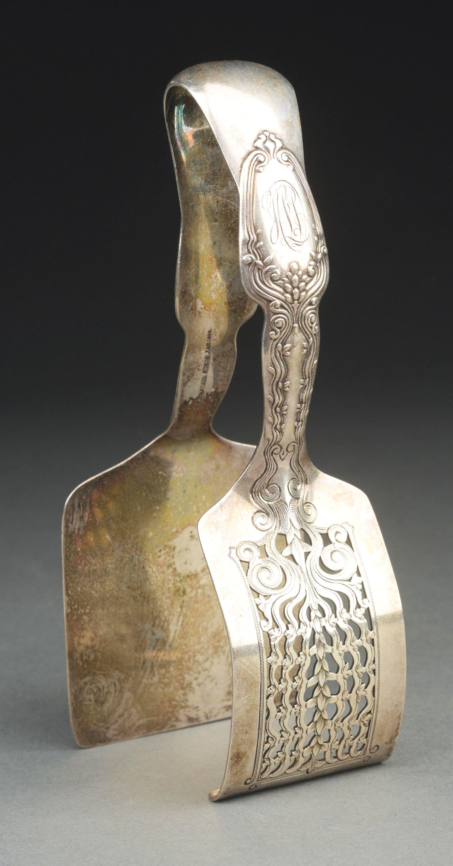 A PAIR OF TIFFANY STERLING TONGS. (1 of 4)