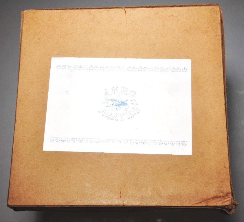 Akro Agate No. 1 Box Set of Prize Name Marbles.: Box contains 100 two-color corkscrew marbles. Three of the box corners are torn away from the metal but tabs are still attached. Marbles: 11/16" Dia. Condition: (9.0).