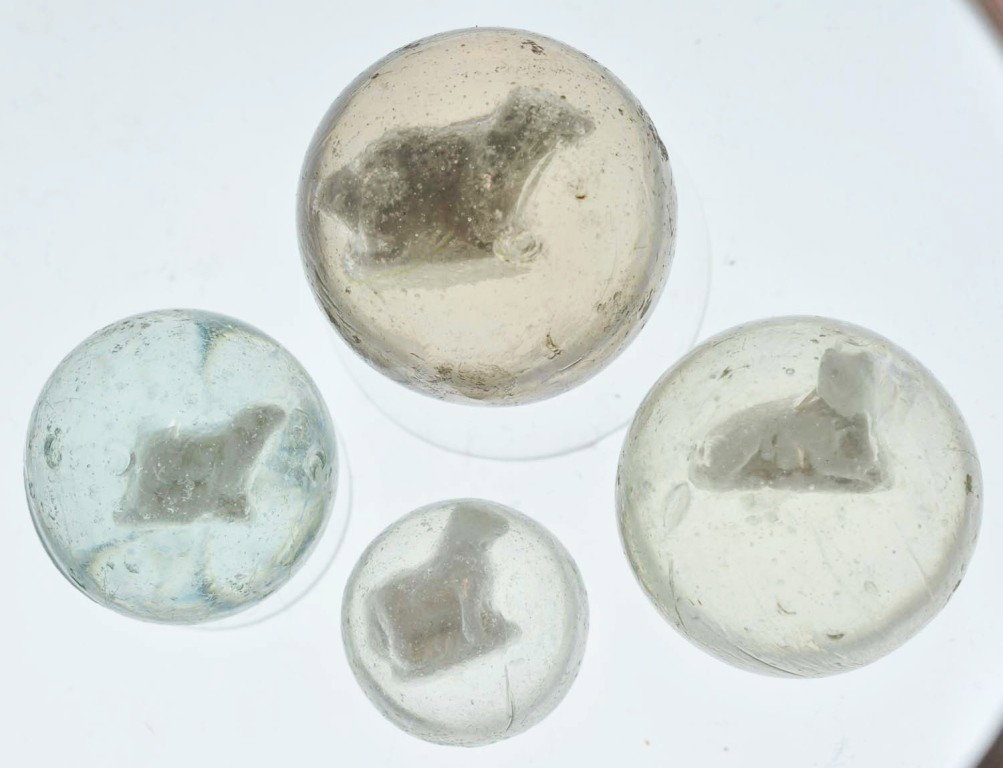 Lot of 4: Sulphide Marbles.: Smallest marble is a standing pony in hard-to-find size and the largest is a lying cat. Lot also includes two standing dogs. Range: 7/8" to 1 - 3/8" Dia. Condition: (8.7).