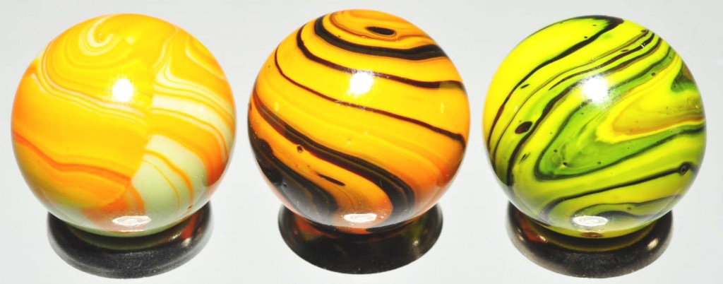 Lot of 3: Christensen Diaper Fold Marbles.: Includes one with black base and electric orange, one with green base and electric orange, and one with black base and electric yellow. Great color coverage on all three marbles. Some as-made indentat