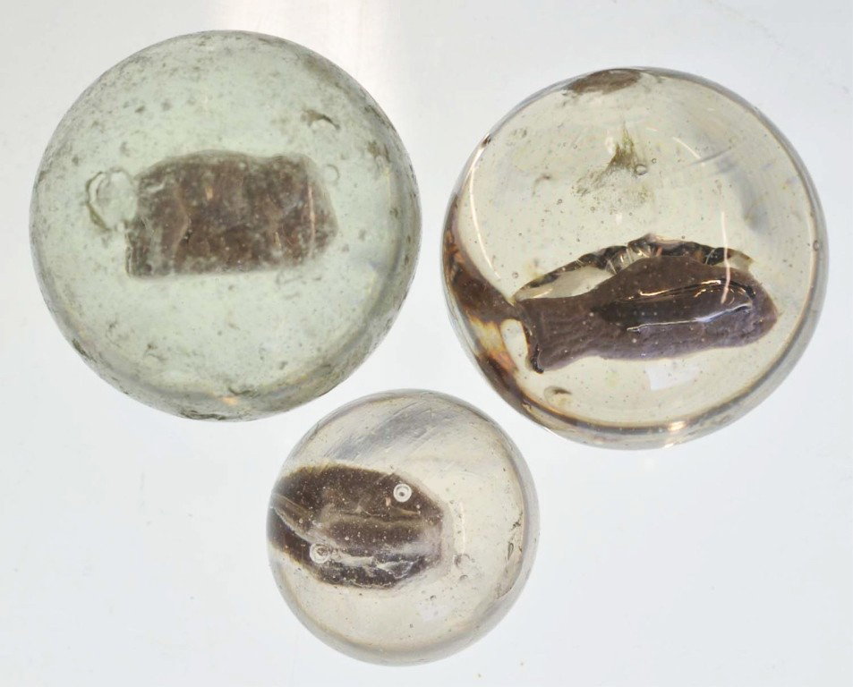 Lot of 3: Sulphide Marbles.: Includes one lizard on rock, one elephant, and one fish with an internal as-made fracture. Range: 1 - 7/16" to 2 - 1/32" Dia. Condition: (8.5).