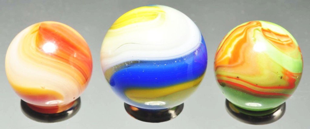 Lot of 3: Machine Made Marbles.: Group includes one 3/4" blue and yellow Popeye and one 5/8" hybrid Popeye in yellow, pink, orange, and red. Also includes one lime green base Christensen Diaper fold with electric orange. Range: 5/8" 