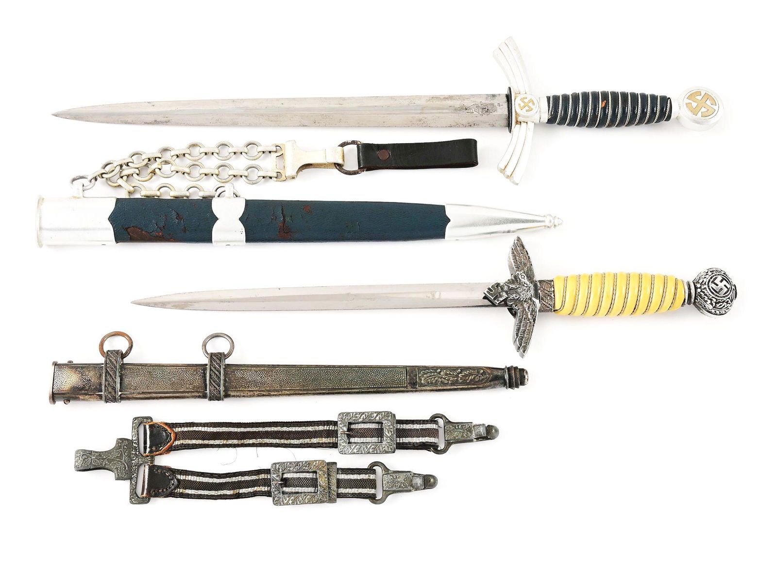 LOT OF 2: THIRD REICH LUFTWAFFE FIRST & SECOND MODEL DAGGERS.: Lot contains: (A) Luftwaffe 1st Model dagger with a "SMF, Solingen" marked blade with moderate runner and scattered marks, as well as light freckling and staining throughout. The blade may clean up. A