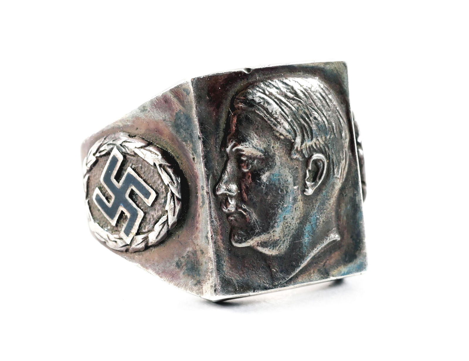 SILVER ADOLF HITLER RING.: Silver ring marked ".835" with a bust of Hitler on the top panel, and 2 black enamel swastikas in a wreath on the side panels. Unknown as to when it was made. CONDITION: Overall very good to excellent