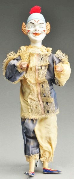 Bisque Head Clown Clapper.: Well-modeled bisque head with painted and molded clown decoration, incised "2 AC." Wood torso with bellows, wire arms and legs, wood hands and feet. Original clown costume. When bellows is pressed he