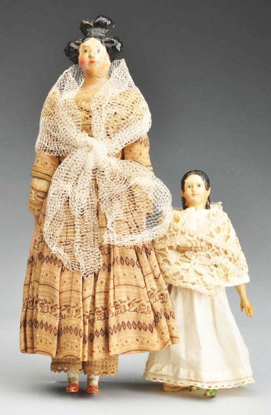 Lot of 2: German Papier-Mâché Lady Dolls.: Papier-mâché shoulder plate, black molded hair in desirable Apollo knot style, painted facial features (restoration to face); original kid body with wood lower arms and legs; original cotton print d