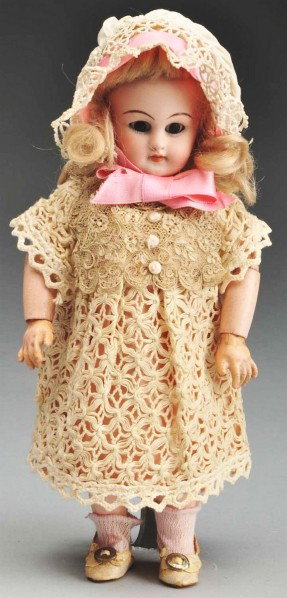 Rare Size Simon & Halbig 749 French Trade Doll.: Bisque socket head incised "749 Dep 3/0." Long tapered eyebrows, brown sleeping eyes, painted lower eyelashes, no upper eyelashes, open mouth with upper square cut teeth, original blonde mohair wig wi