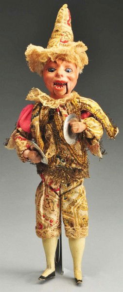 Papier-Mâché Head Clown Clapper.: Well-modeled papier-mâché head with mouth joint showing teeth, glass inset eyes. Wood torso with bellows, wire arms and legs, wood hands and feet. Original clown costume. When bellows is pressed he