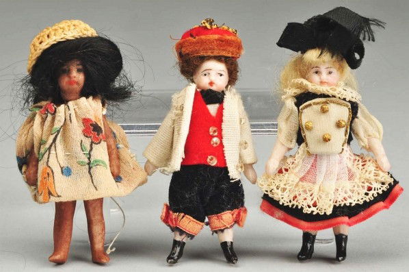 Lot of 3: All-Bisque Child Dolls.: German boy and girl pair with mohair wigs, painted features, jointed shoulders and hips, black boots with magenta garters, all original Regional outfits. They are in a sweet old box with a sailor boy