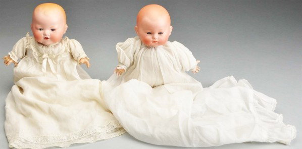 Lot of 2: Baby Dolls.: Both have German bisque heads with flange necks, original cloth bodies and composition hands. One is an A.M. 351 baby with open mouth and teeth; one is a Baby Phyllis with closed mouth. Both are weari