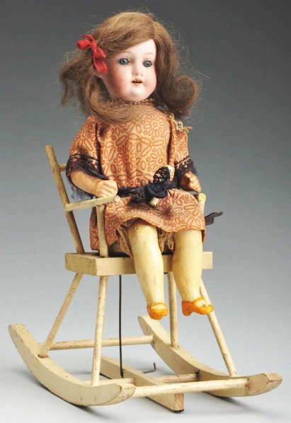 Mechanical Girl in Rocking Chair.: German bisque socket head incised "Armand Marseille 390," glass eyes, original mohair wig, wood torso, composition lower limbs, original cotton dress (soiled). In a wooden rocking chair with key wind 