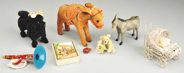 Lot of Doll Accessories.: Tiny antique all-bisque baby in a white wire carriage (carriage needs repair); vintage cloth donkey pincushion; vintage curly mohair poodle; Papier-mâché donkey, vintage tin horn; cardboard box with