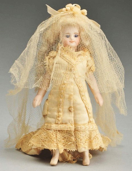 French All Bisque "Mignonnette" Bride with Boots.: Bisque socket head, original blonde wavy mohair wig, long tapered one-stroke eyebrows, blue inset glass eyes, painted upper and lower eyelashes, closed smiling mouth. Swivel neck, pegged shoulders and