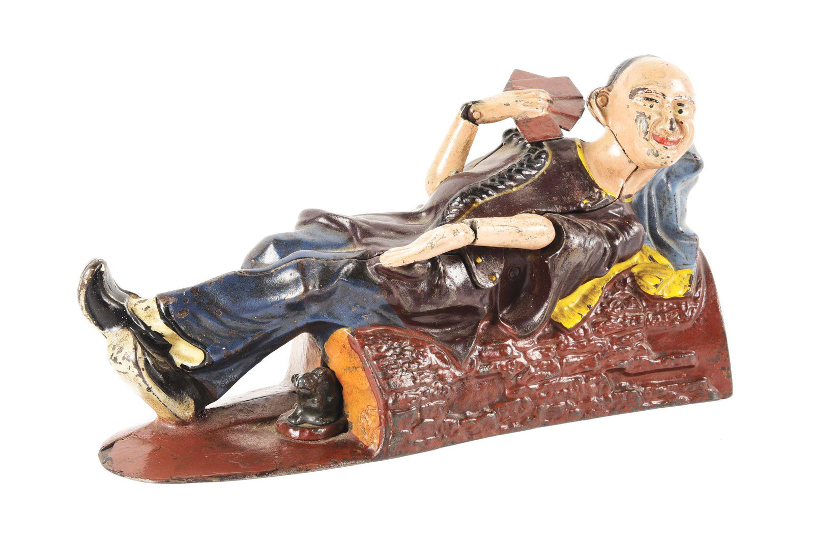 RECLINING CHINAMAN MECHANICAL BANK.: J & E Stevens. One Arm has been repaired and repair to the base of the bank. Condition: (Very Good). Dimensions: 8 - 1/2" x 4 - 1/2" x 2 - 1/2".