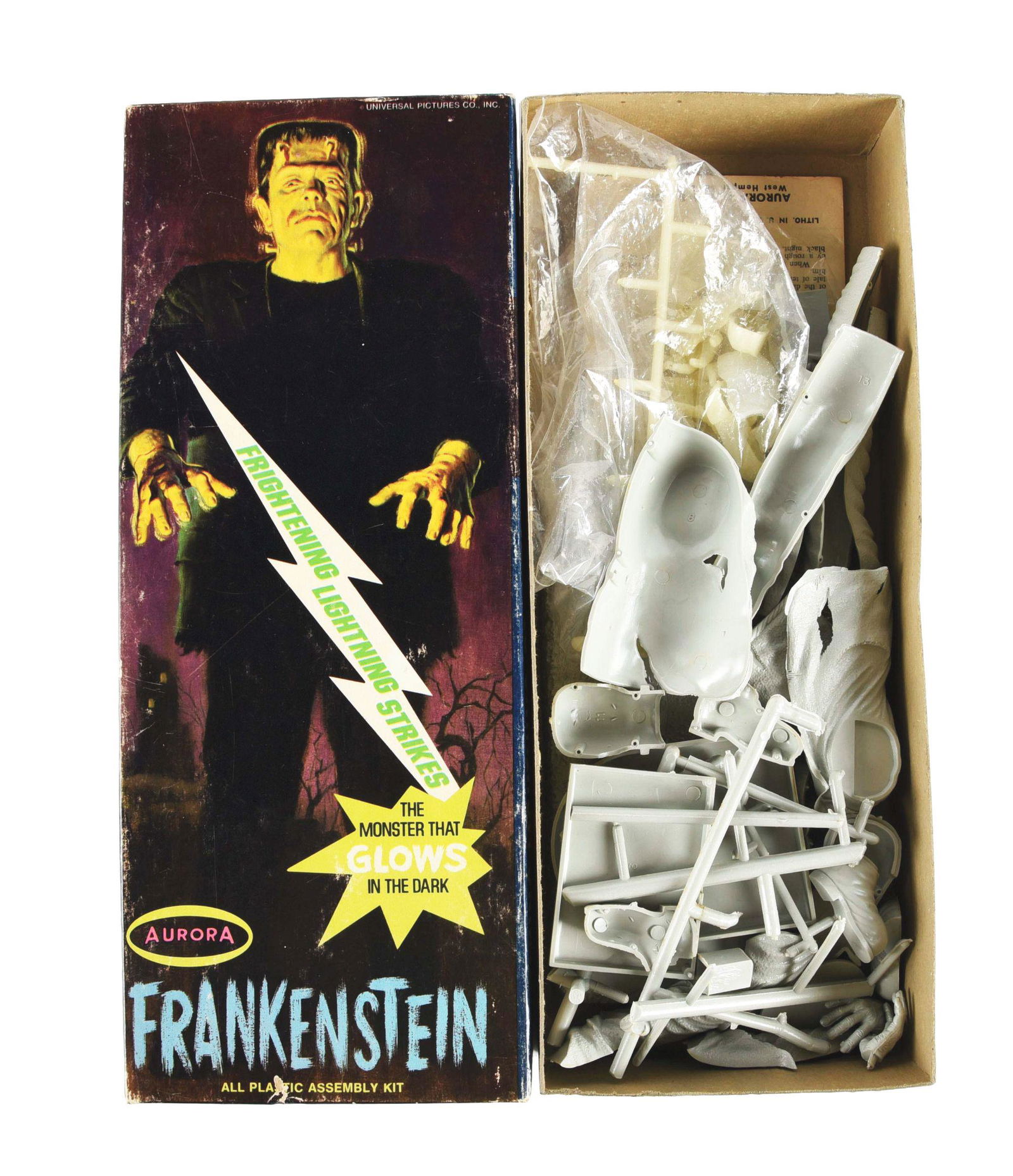 AURORA FRANKENSTEIN MODEL KIT.: Kit No. 449-150 in the original box, "Frightening Lightning Strikes Glow in the Dark" version, marked "1969 Aurora Plastics". Depicts Frankenstein walking on front of box. Instructions are present, pi