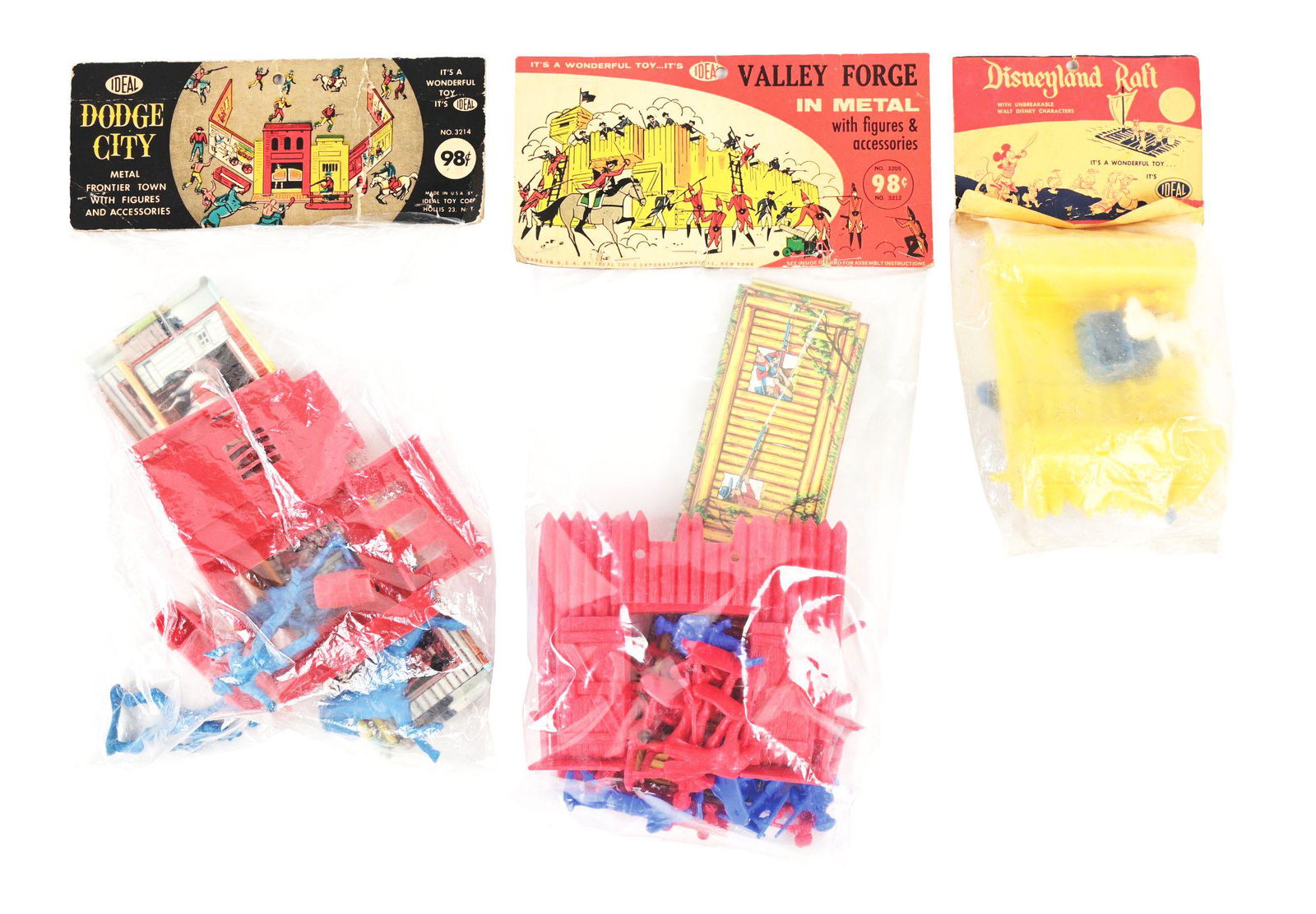 LOT OF 3: IDEAL FIGURE AND VEHICLES PLAY SETS.: Lot of three includes: a Dodge City, a metal frontier town with figures and accessories; a Disneyland Raft, which has a plastic raft with some Disney characters including Mickey Mouse; and a fairly sc