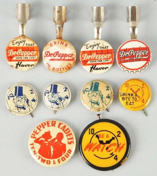Group of Dr. Pepper Pinbacks & Pencil Clips.: 1920s to 1950s. Most items are quite enjoyable and presentable. Three of the clips have some marks and stains but only three of the pinbacks have anything past light wear, with just a few small marks 