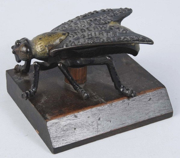 Green, Joyce, & Co. Hosiery & Shirts Match Holder: Designed as an embossed metal house fly with wings and upper bottom opening to reveal storage compartment. General overall light wear and soiling. Two of the legs on the right side of the fly are brok
