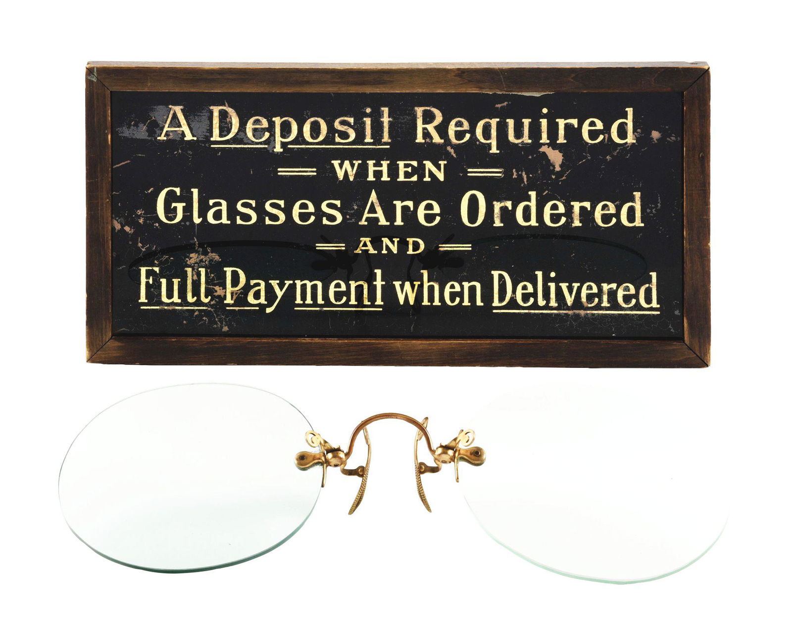 LOT OF 2: SPECTACLE PIECES.: The first is a reversed glass sign with gold lettering. Some scattered wear throughout. In a period frame. Overall condition is good. Reads, "A Deposit Required when Glasses Are Ordered and Full Payme