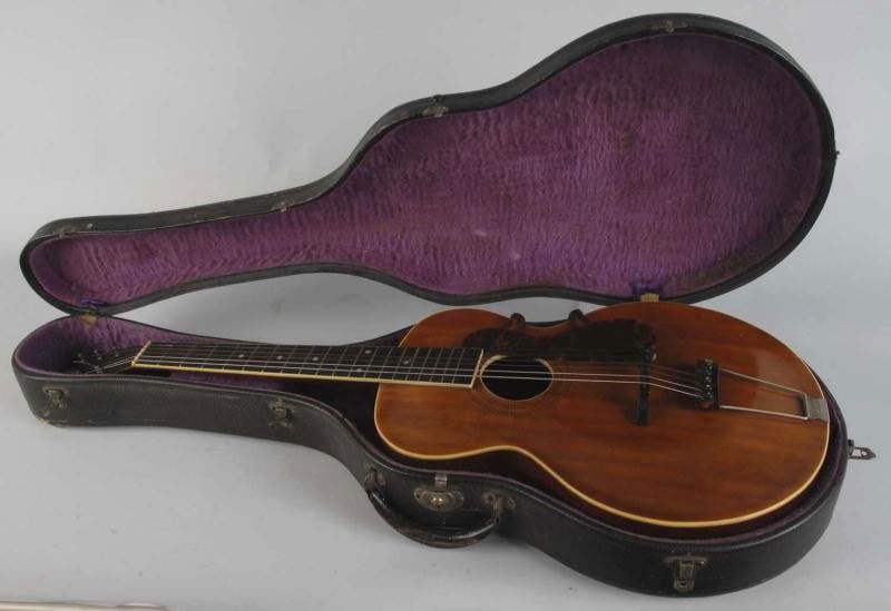 Gibson Acoustic Guitar.: Patented 1910. Model L1. Comes with original case. Two hairline cracks through wood on right side and some overall light wear. Size: 39" L.