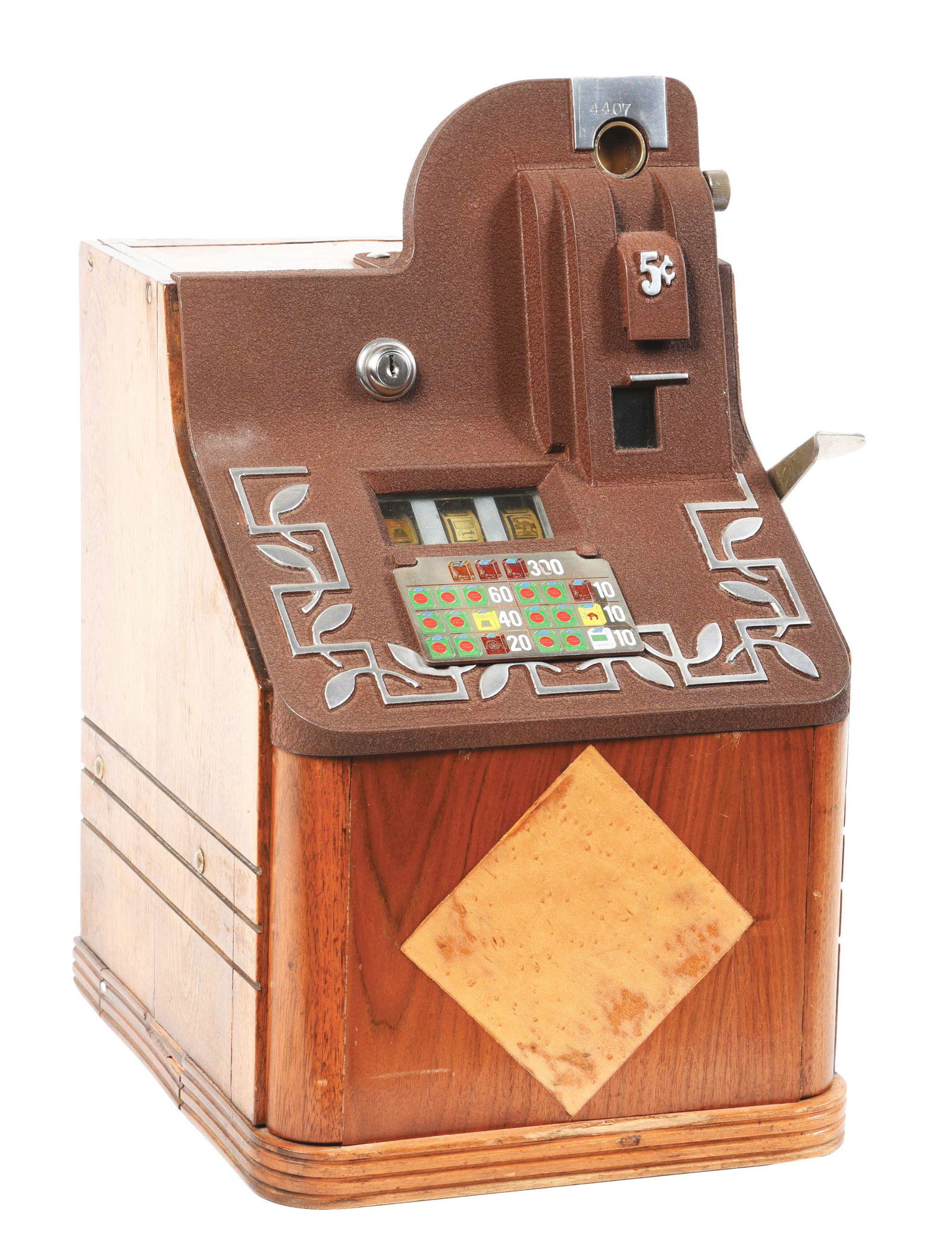 MILLS QT SLOT MACHINE.: 1939, USA: This is a 5¢ Mill QT Smoker slot machine. This miniature bell slot machine features a nice sleek wood finish. This particular model front plate shows cigarettes for trade, Lucky Strike