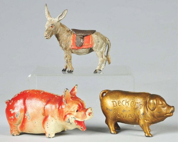 Lot of 3: Cast Iron & Lead Animal Still Banks.: Includes one lead mule with opening saddle on hinge (missing lock), one cast iron Decker's Iowana pig, and one cast iron pig bank. Moderate overall paint loss and wear. Size: Largest: 5 -1/2" L.