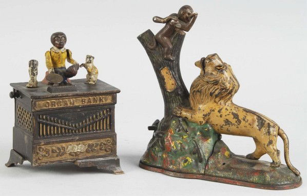 Lot of 2: Cast Iron Mechanical Banks.: Includes one Lion and two Monkeys (missing small monkey) and one Organ Dancing Cat and Dog with one crack and missing front left leg. Size: Largest: 9" L.