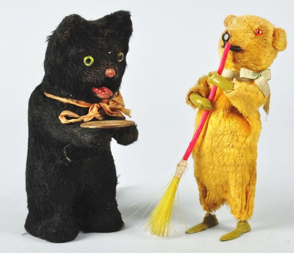 Lot of 2: Fur-Covered Animal Wind-Up Toys.: Japanese. Working. Includes one bear with lead feet and celluloid hands and broom and one cat holding a tin plate in his hands. Both toys with some wear overall. Size: Largest: 6 - 1/2" T.