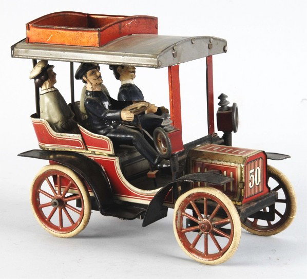 Tin Litho Carette No. 50 Automobile Toy.: German. Original rubber tires, roof, and roof rack. Side lamps and all four figures are replaced. Moderate overall wear. Size: 8 - 1/2" L.