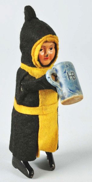 Schuco Munich Maiden Figural Wind-Up Toy.: German. Working. Marked "Schuco" on feet. When in operation, girl brings a beer mug up to her face while she dances around. Some wear to the fur covering. Size: 5" T.