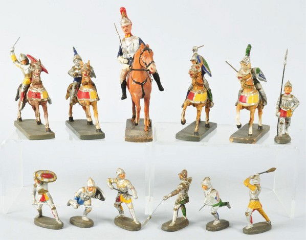 Lot of 17: Elastolin Medieval Knights.: Circa 1950. Made in Germany. Early post-war production. Includes four mounted knights, six on foot (two weapons damaged) and an Elastolin British horse guard. Some paint loss and minor cracks.