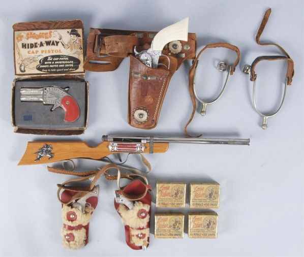 Lot of Toy Guns & Spurs.: Includes one Hideaway cap pistol in original box, four boxes of Lone Rider caps in original boxes, one small double holster set with two Kilgore Little Smoky pistol, one single holster set with Pony B