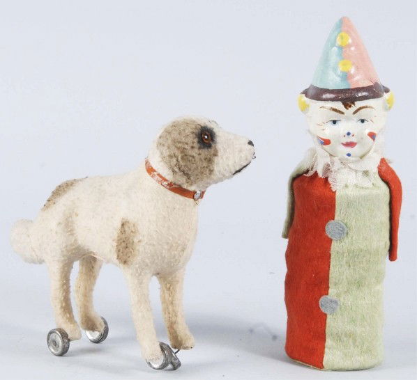 Lot of 2: Figural Clown & Dog Toys.: Includes one fur-covered dog with glass eyes and wheels below the feet and one composition/paper mache clown head squeak toy that no longer works. Both have some overall wear. Size: Largest: 8 - 1/4"