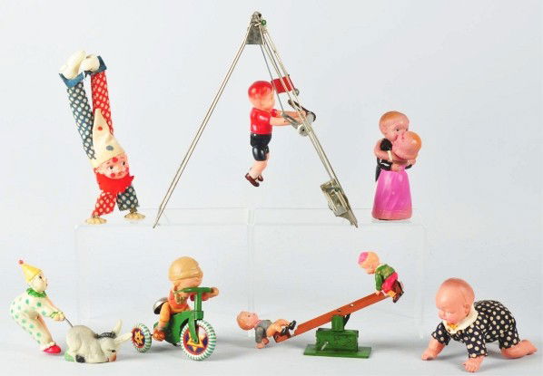 Lot of 7: Celluloid Wind-Up Toys.: Japanese. Pre-war. Includes Obstinate Donkey with original box and Dancing Couple with partial original box, and five other miscellaneous toys. Bicycle rider toy needs arms re-strung. Size: Largest: 1