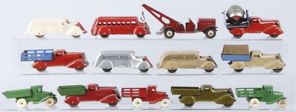 Lot of 13: Pressed Steel Marx & Girard Toys.: American. Includes two armored bank truck still banks, one ambulance, one bus, one tow truck, one cement mixer, and seven dump trucks. Size: Largest: 7 - 3/4" L.