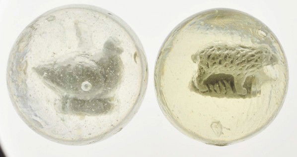 Lot of 2: Sulphide Marbles.: The larger marble is a hen on a nest with one air bubble on left wing. The smaller marble is a bear with an air bubble on the left side. Size: 1 - 5/8" & 1 - 11/16" Dia.
