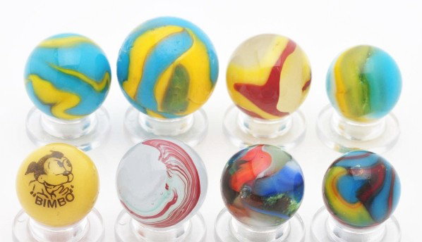 Lot of 8: Machine Made Marbles.: This lot includes four Peltier National Rainbows, one Peltier Superman, one Peltier Bimbo comic, one Akro egg yolk oxblood, and one Akro silver oxblood. Size: Range: 5/8" to 7/8" Dia.